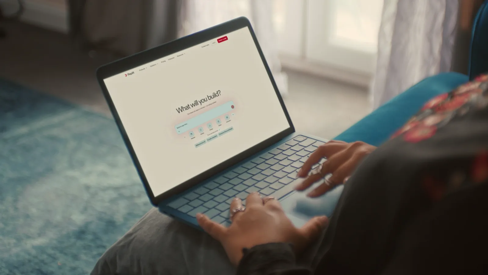 A laptop showing Replit’s “What will you build?” prompt