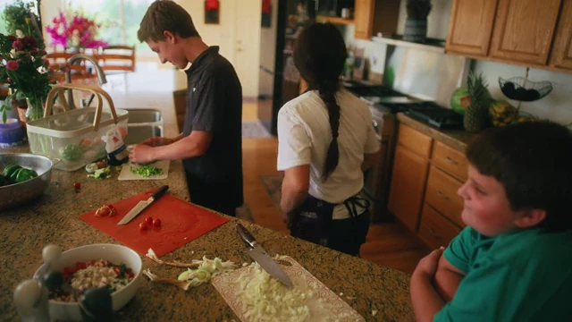 Jon’s family preparing food together in their kitchen