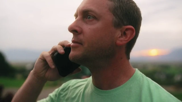Jon Cheney on a phone call outdoors at home